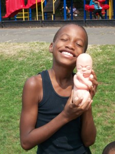 adorable kid holding baby model in Irvington